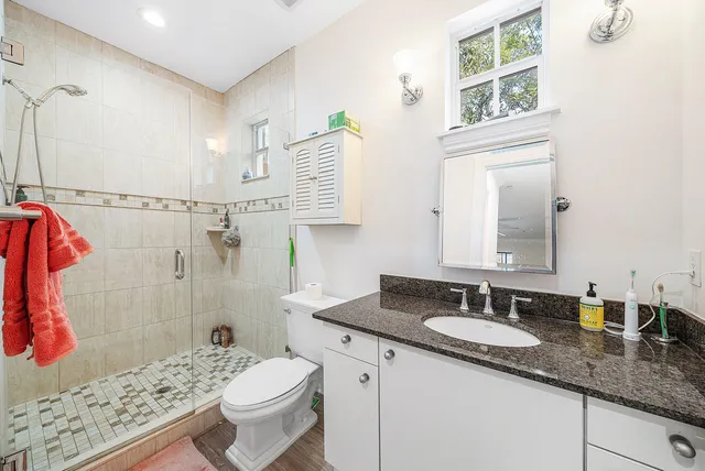 a bathroom with a sink toilet and shower