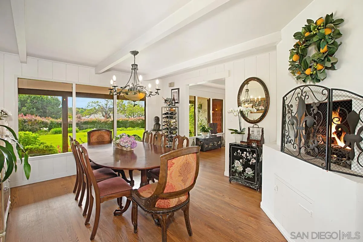1465 Rodeo Drive La Jolla, CA 92037 - Photo 12 of 24 a dining room with furniture clock and a large window