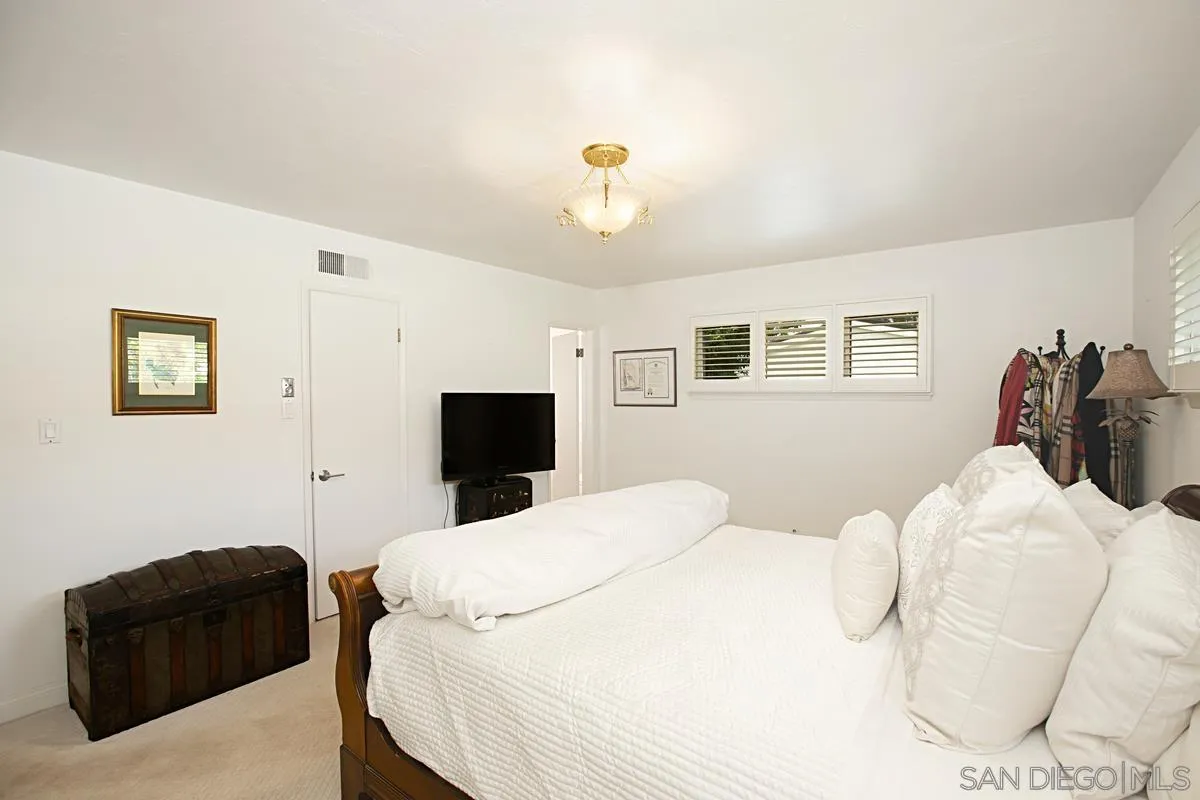 1465 Rodeo Drive La Jolla, CA 92037 - Photo 16 of 24 a bedroom with a bed and window