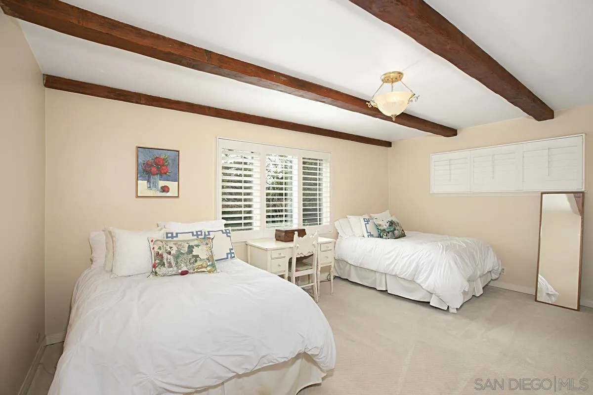 1465 Rodeo Drive La Jolla, CA 92037 - Photo 18 of 24 a bedroom with two beds and a large window