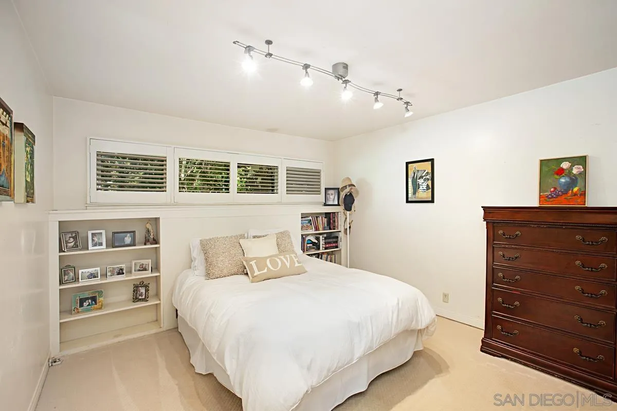 1465 Rodeo Drive La Jolla, CA 92037 - Photo 19 of 24 a bedroom with a large bed and a dresser