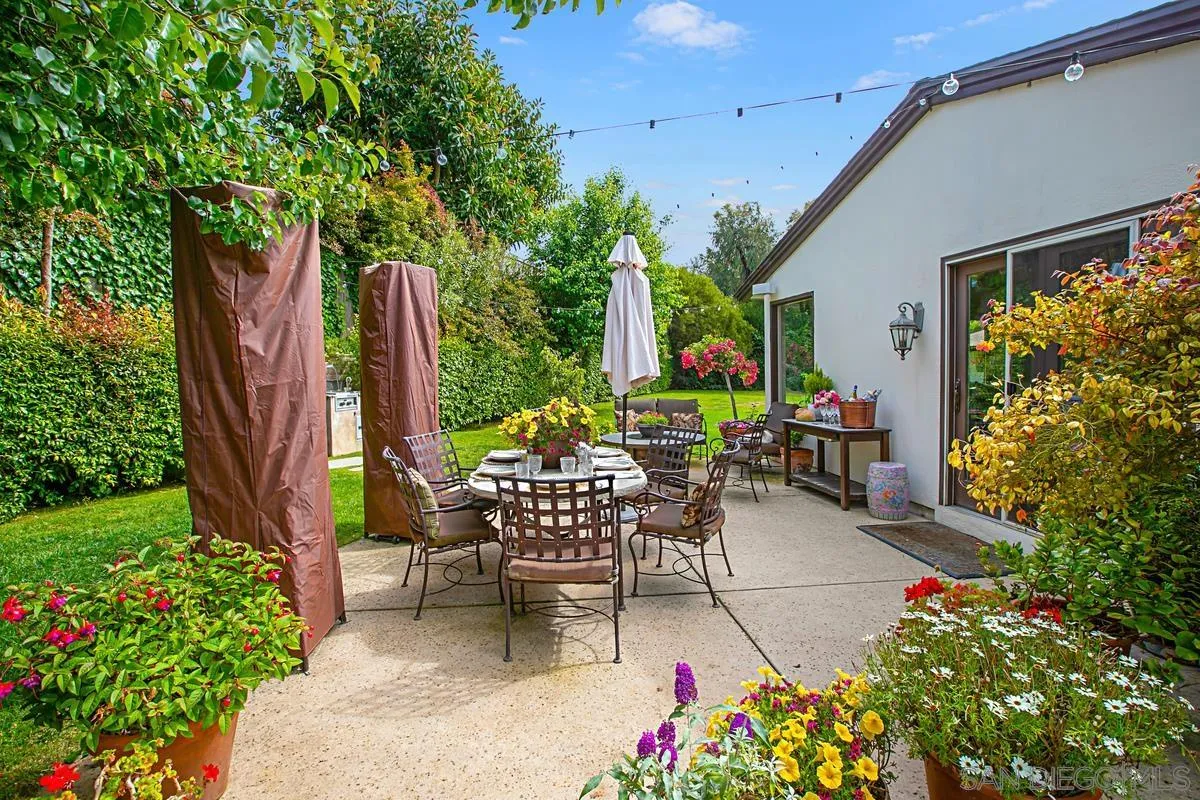 1465 Rodeo Drive La Jolla, CA 92037 - Photo 22 of 24 a view of a patio with table and chairs potted plants and large tree