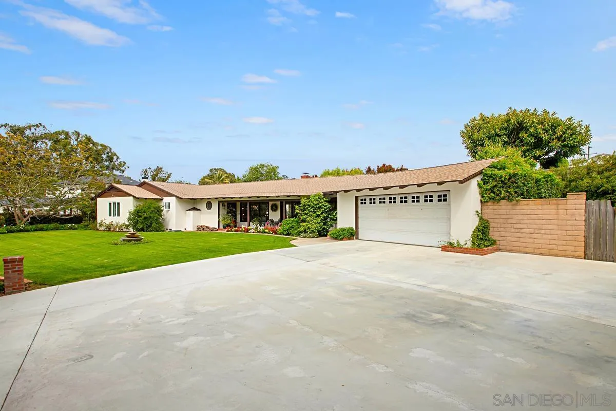 1465 Rodeo Drive La Jolla, CA 92037 - Photo 3 of 24 a view of a house with a yard and garage