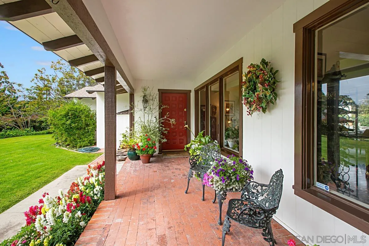 1465 Rodeo Drive La Jolla, CA 92037 - Photo 7 of 24 a porch with a bench and potted plants