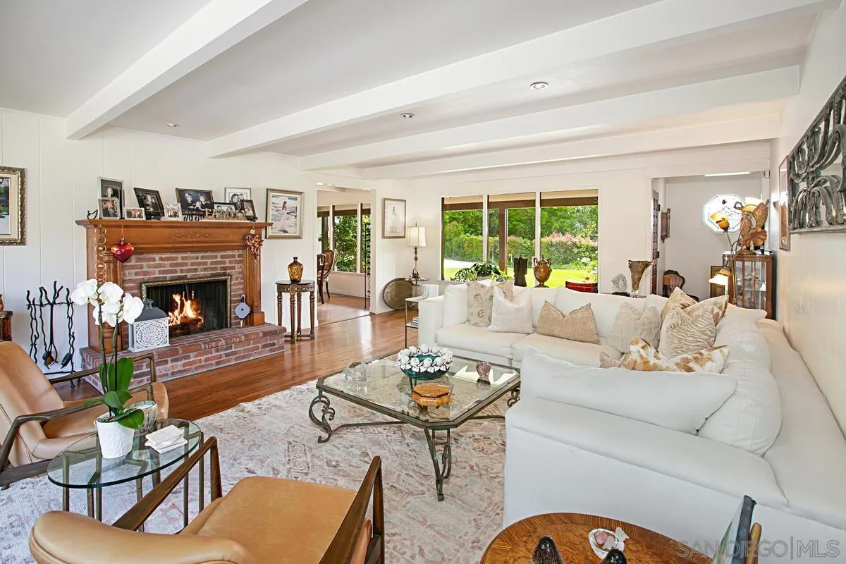 1465 Rodeo Drive La Jolla, CA 92037 - Photo 9 of 24 a living room with furniture fireplace and a large window