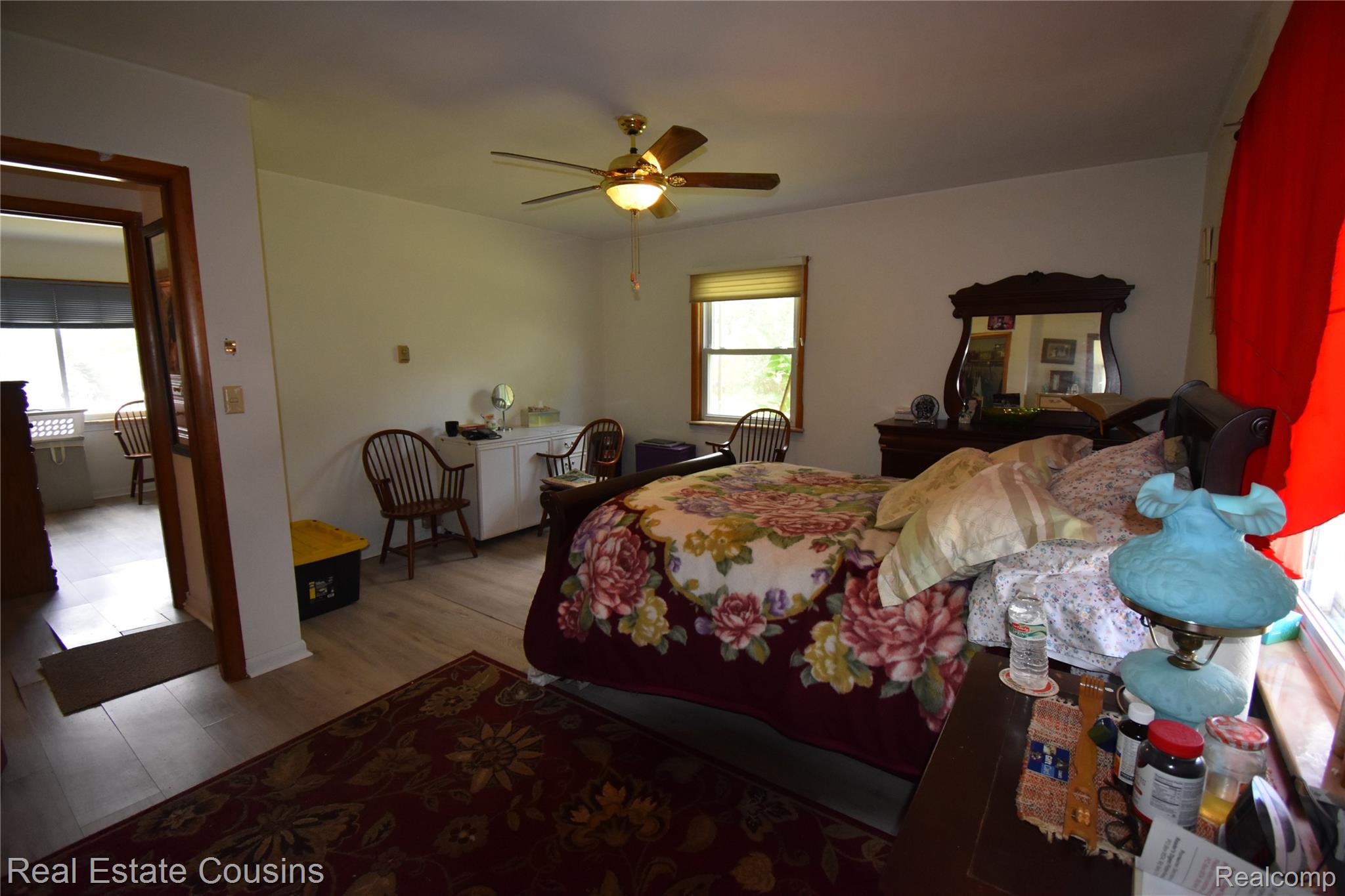 2247 Johnson Mill Road North Branch, MI 48461 - Photo 13 of 22 Spacious interior featuring wood-finish flooring, a ceiling fan with integrated lighting, and multiple windows providing natural light