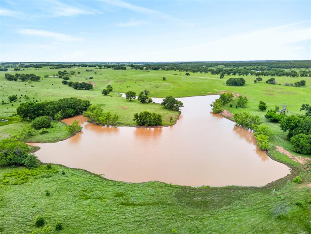 1080 North Greenbrier Road Nocona, TX 76255 - Photo 38 of 40 Expansive body of water surrounded by lush green pastures and scattered trees
