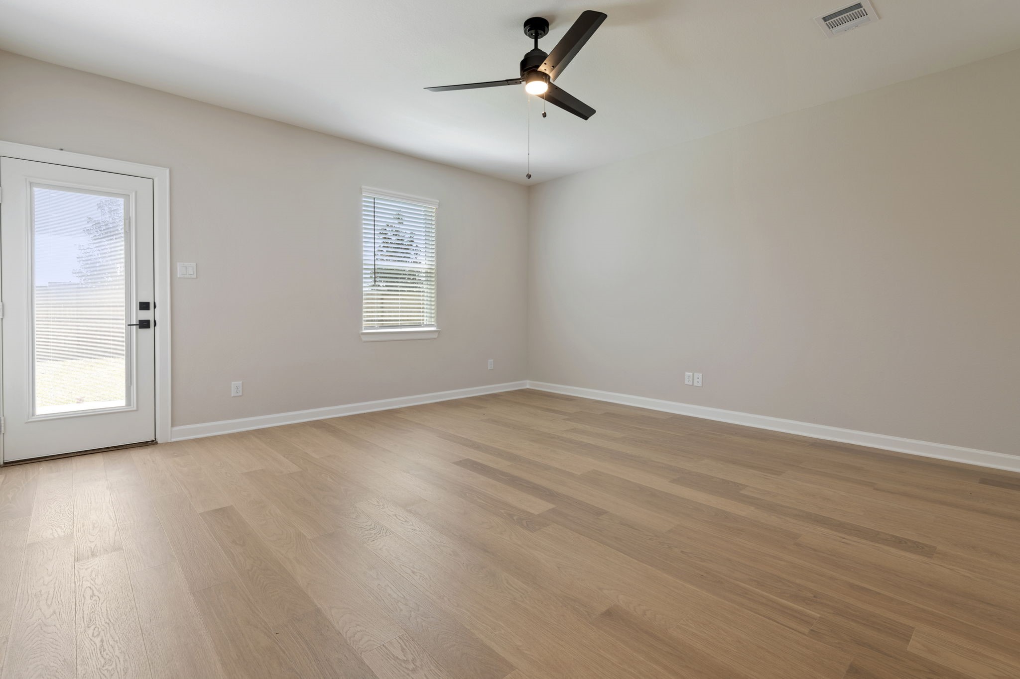 1115 Moonlight Trce Drive Beasley, TX 77417 - Photo 8 of 14 wooden floor in an empty room with a window