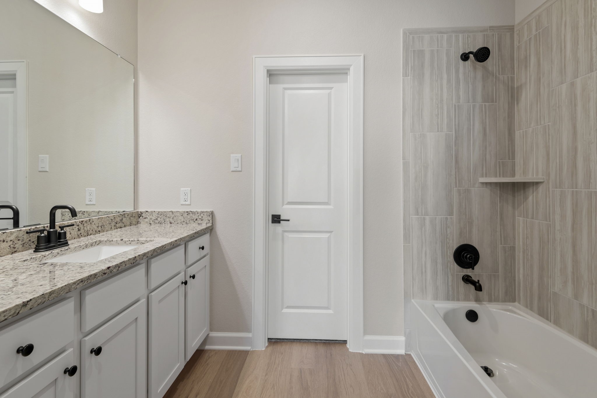 1115 Moonlight Trce Drive Beasley, TX 77417 - Photo 10 of 14 a bathroom with a granite countertop sink and a bathtub