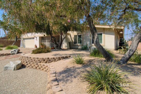 637 Randall Street Ridgecrest, CA 93555 - Photo 2 of 32 a view of a white house with a large tree