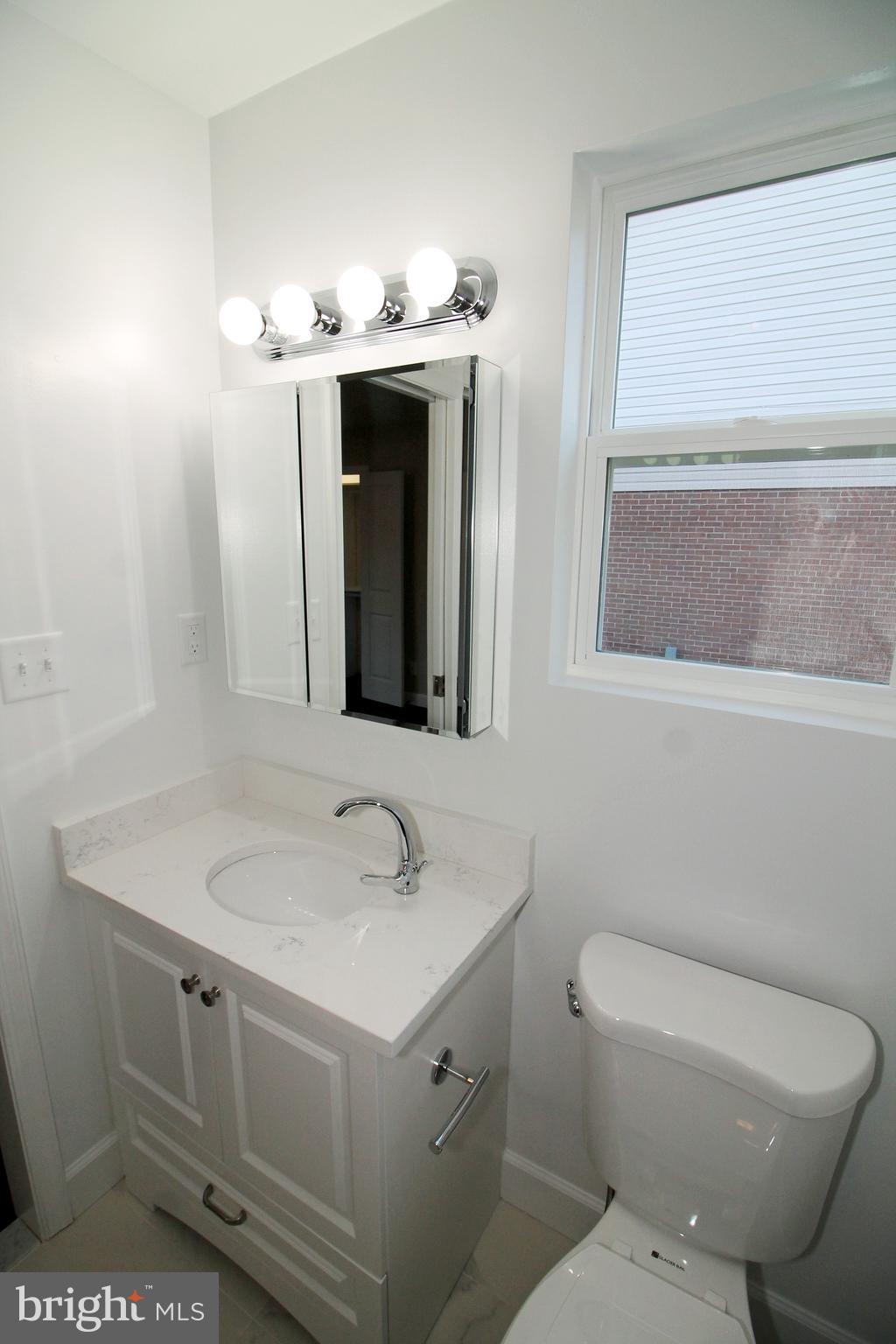 4525 Tapscott Road Baltimore, MD 21208 - Photo 14 of 29 a bathroom with a sink and a toilet