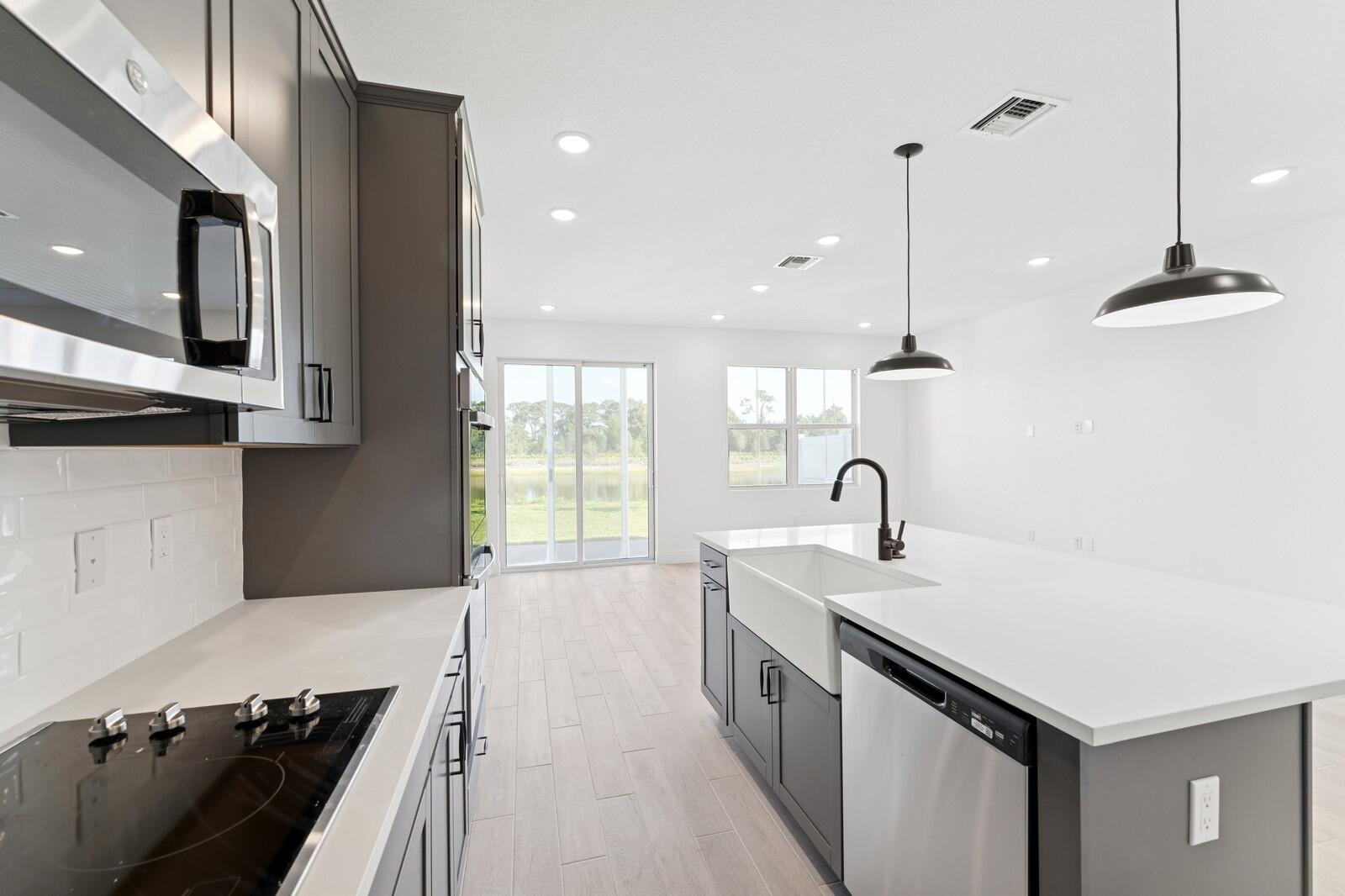 121 Southeast Birch Terrace, Unit 1157 Stuart, FL 34997 - Photo 11 of 34 a kitchen with a sink appliances and cabinets