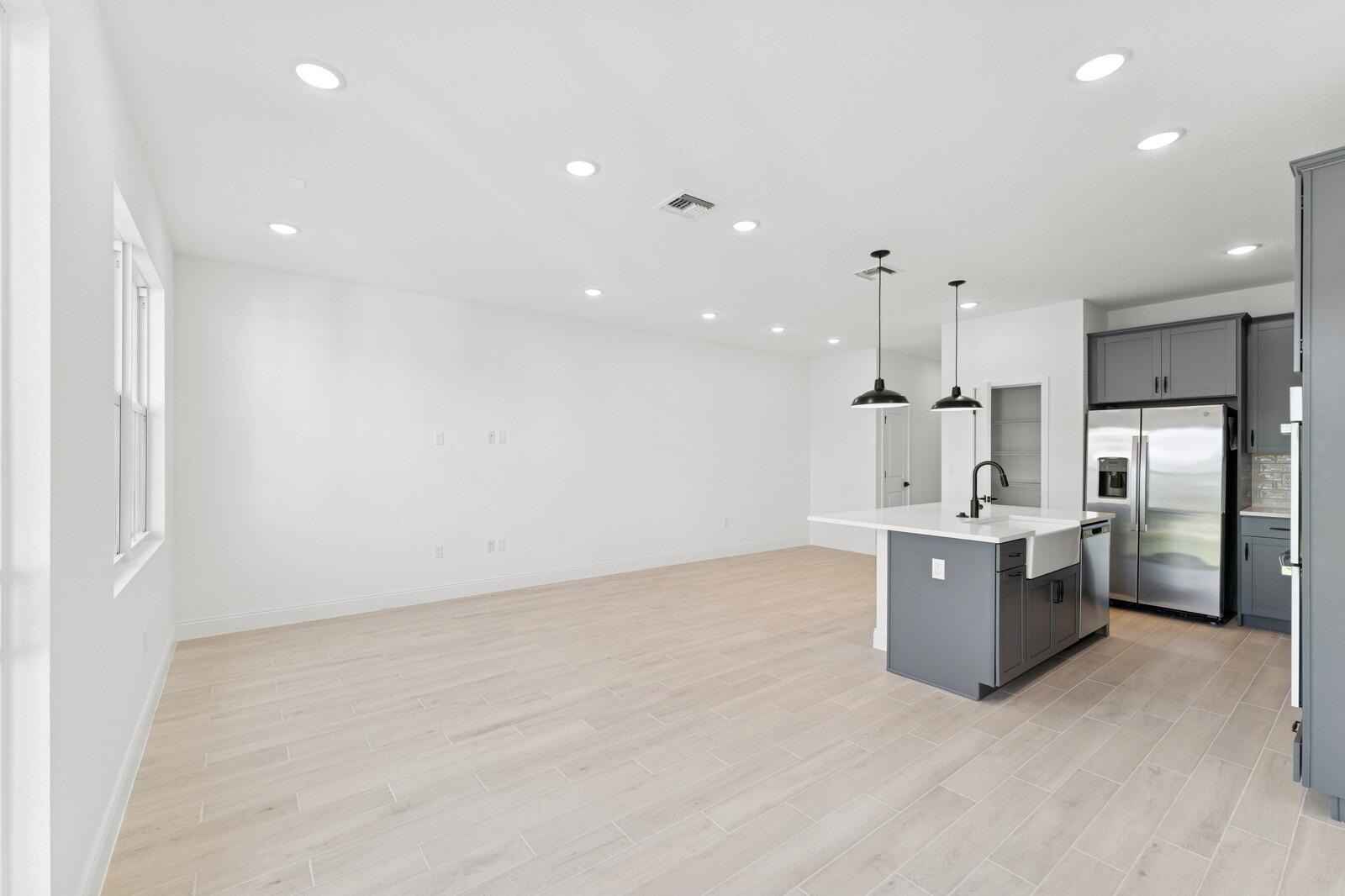 121 Southeast Birch Terrace, Unit 1157 Stuart, FL 34997 - Photo 13 of 34 a large kitchen with a large counter top stainless steel appliances and cabinets