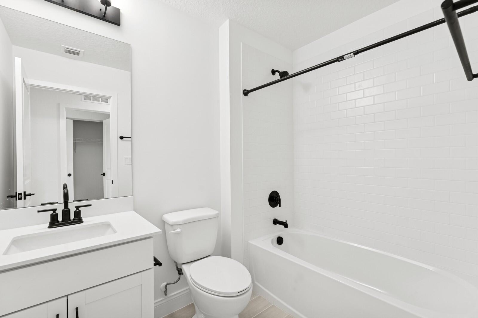 121 Southeast Birch Terrace, Unit 1157 Stuart, FL 34997 - Photo 16 of 34 a bathroom with a sink a toilet and a bathtub