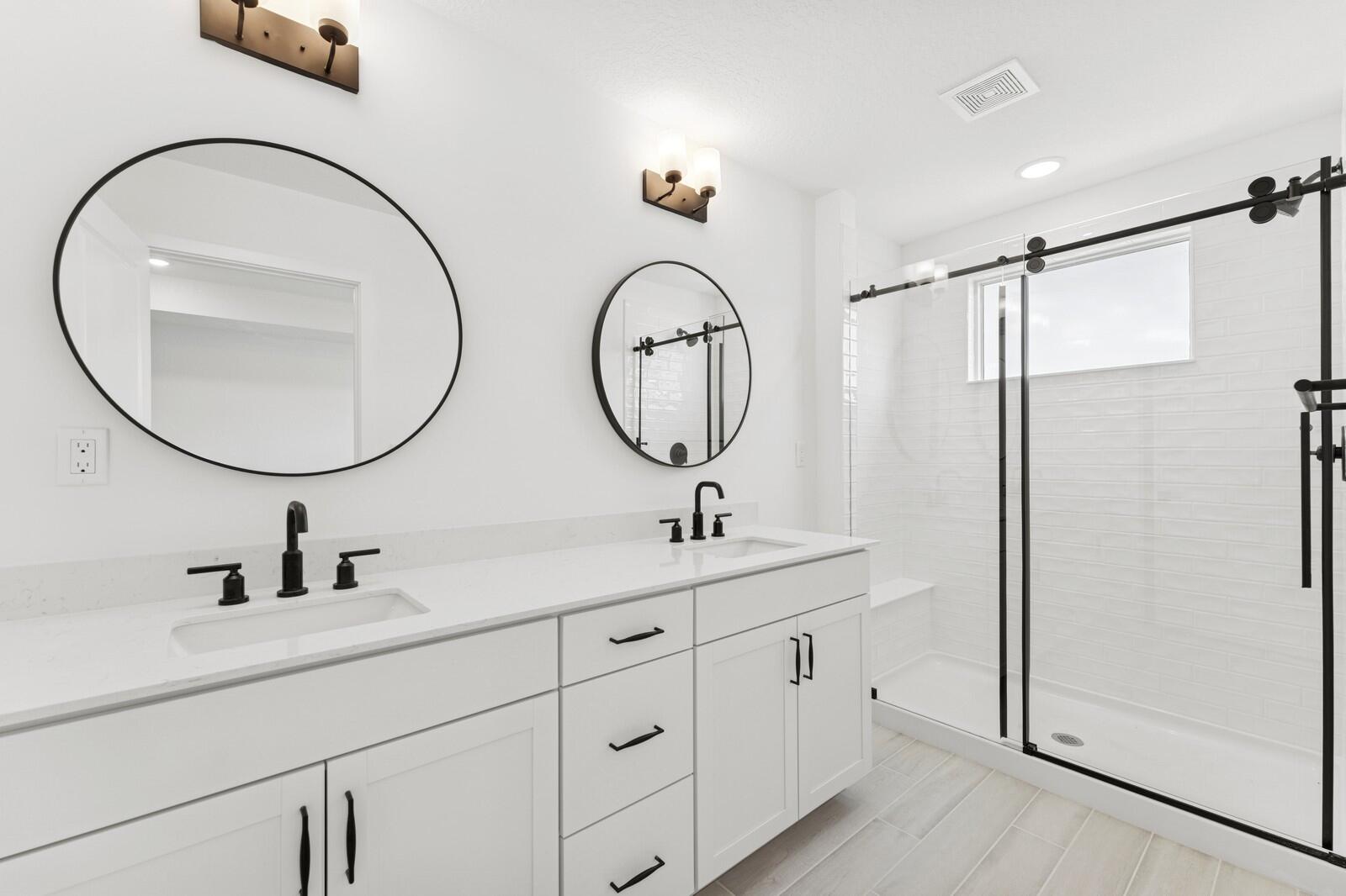121 Southeast Birch Terrace, Unit 1157 Stuart, FL 34997 - Photo 26 of 34 a bathroom with a double vanity sink and a mirror