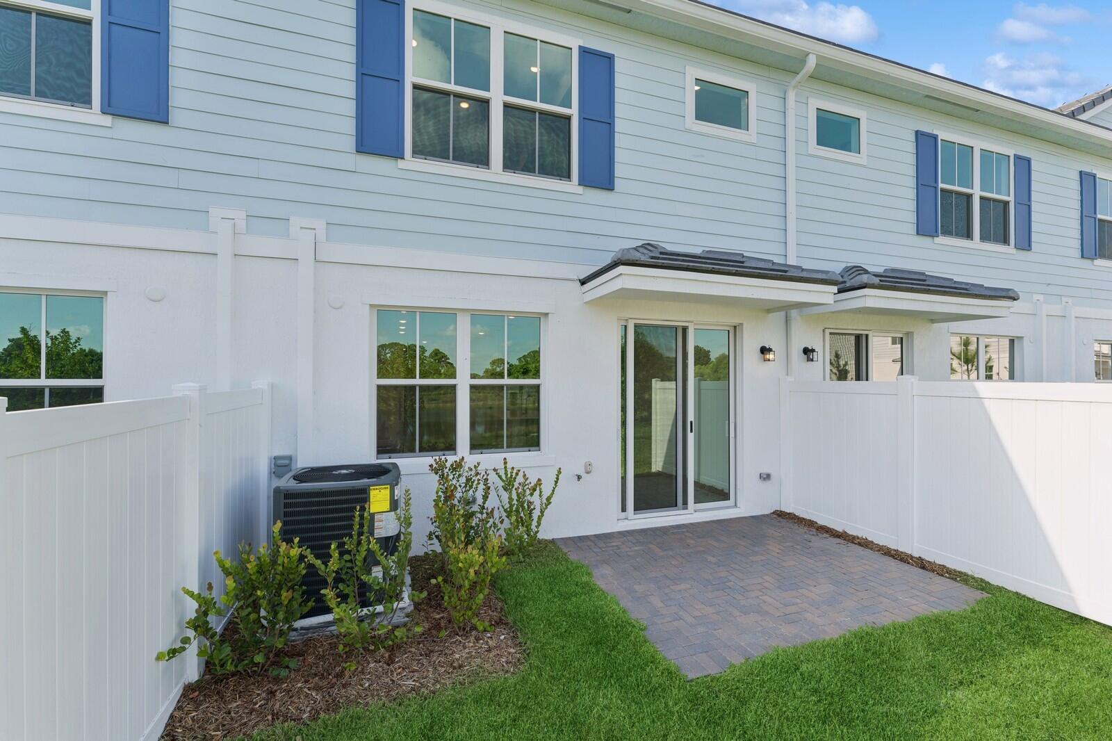 121 Southeast Birch Terrace, Unit 1157 Stuart, FL 34997 - Photo 30 of 34 a view of a house with backyard and garden
