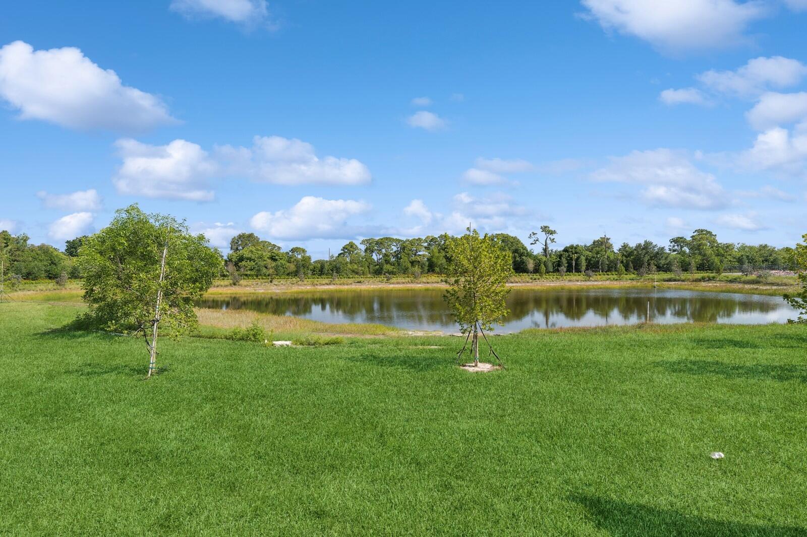121 Southeast Birch Terrace, Unit 1157 Stuart, FL 34997 - Photo 32 of 34 a view of a lake with houses in the background