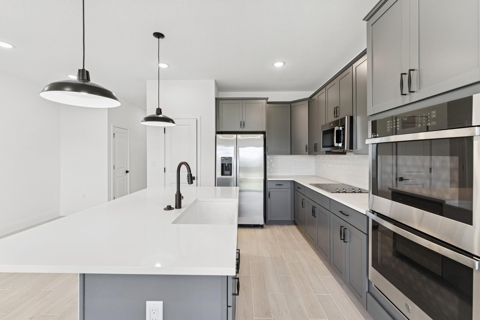 121 Southeast Birch Terrace, Unit 1157 Stuart, FL 34997 - Photo 9 of 34 a kitchen with stainless steel appliances a sink stove and cabinets