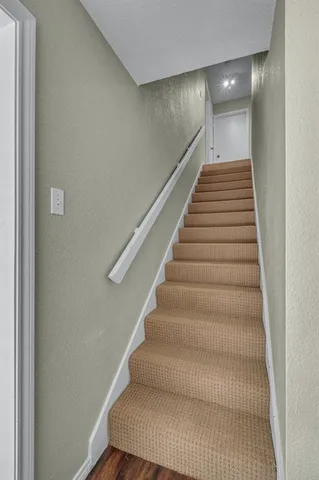 a living room with furniture and a ceiling fan