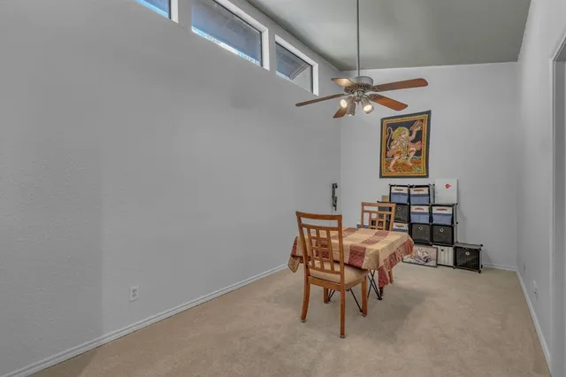 a spacious bedroom with a bed and a chandelier