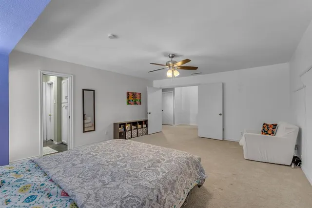 a bedroom with furniture and a large window
