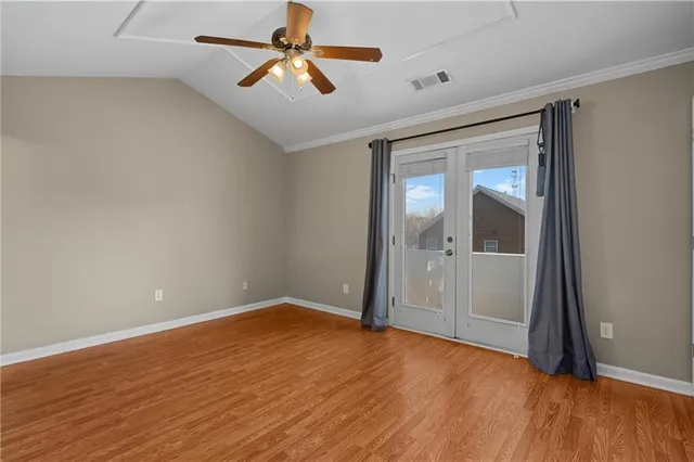 a view of empty room with wooden floor