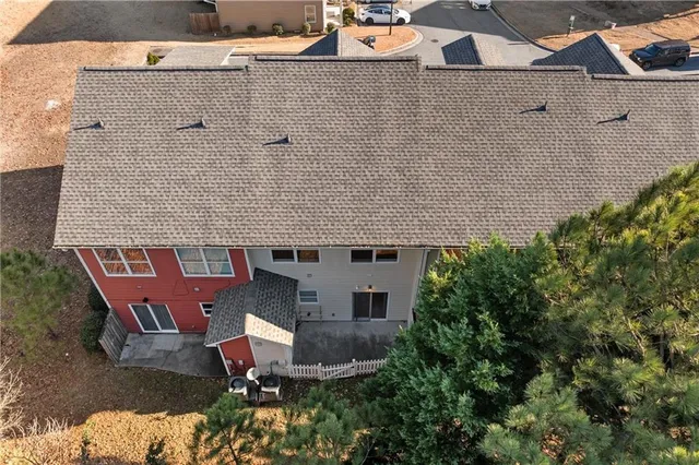 an aerial view of a house with garden space and sitting area