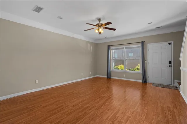wooden floor in an empty room with a window