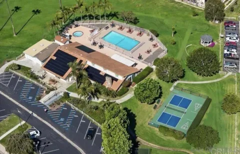 an aerial view of multiple houses with yard