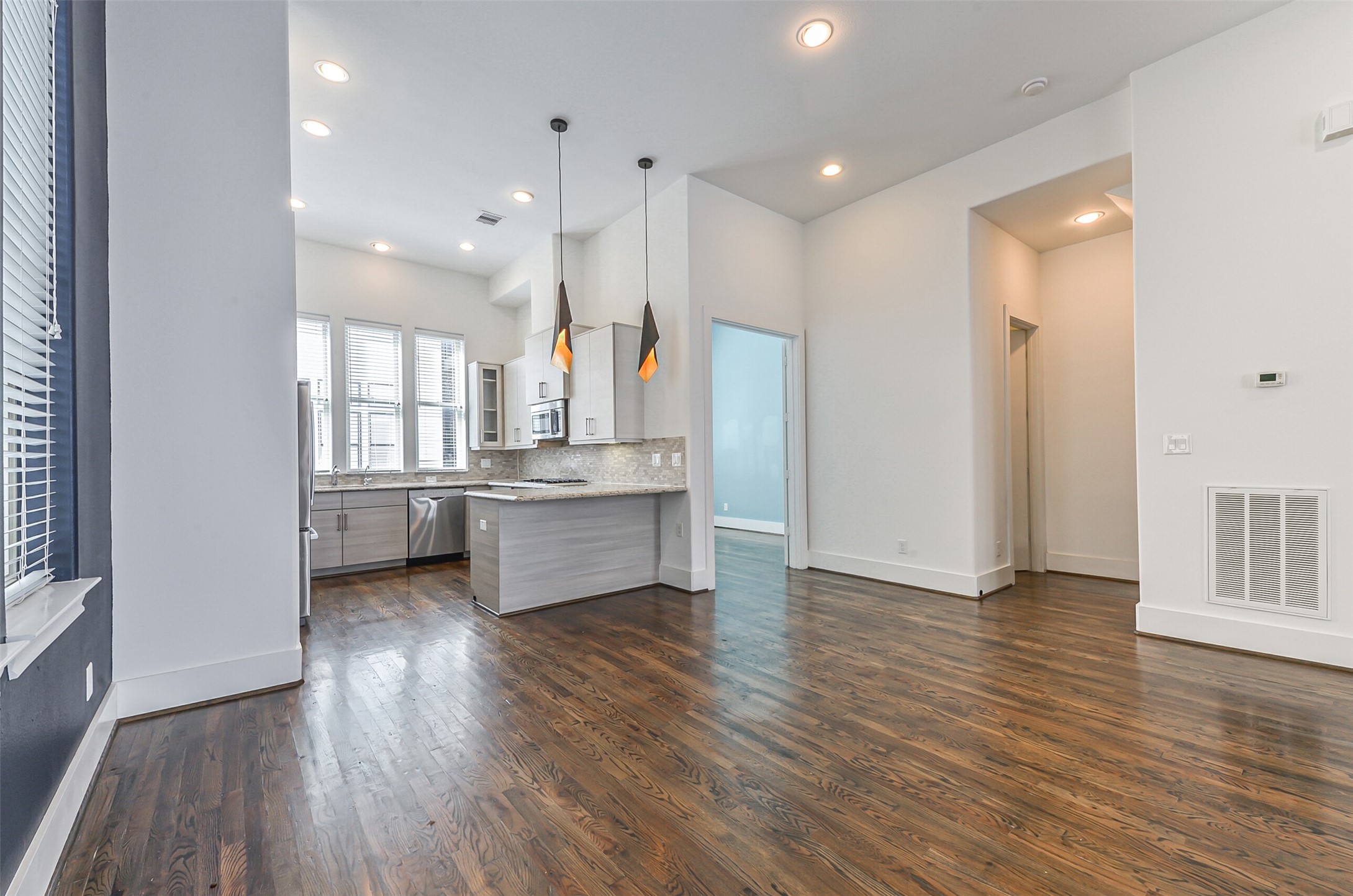 2715 Cohn Garden Lane Houston, TX 77007 - Photo 11 of 23 a view of a kitchen with refrigerator and wooden floor