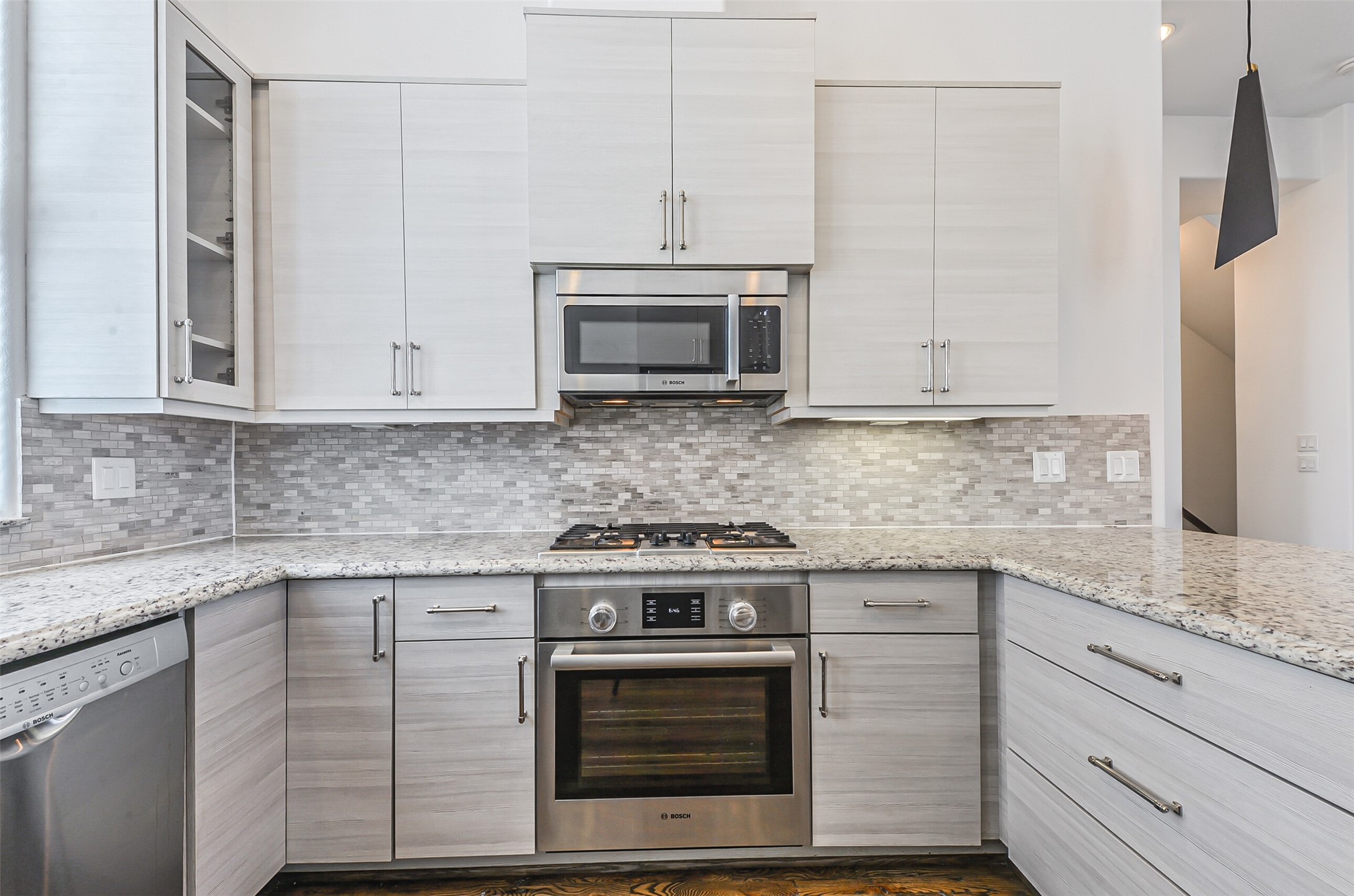 2715 Cohn Garden Lane Houston, TX 77007 - Photo 14 of 23 a kitchen with granite countertop white cabinets and a stove top oven