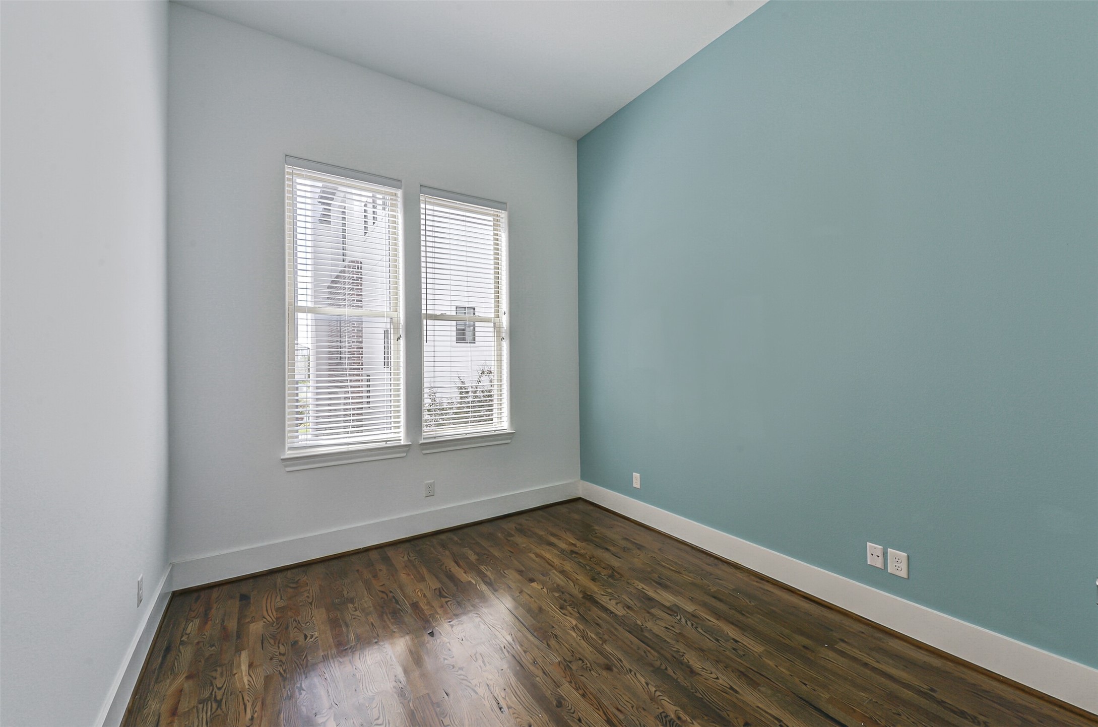 2715 Cohn Garden Lane Houston, TX 77007 - Photo 15 of 23 an empty room with wooden floor and windows