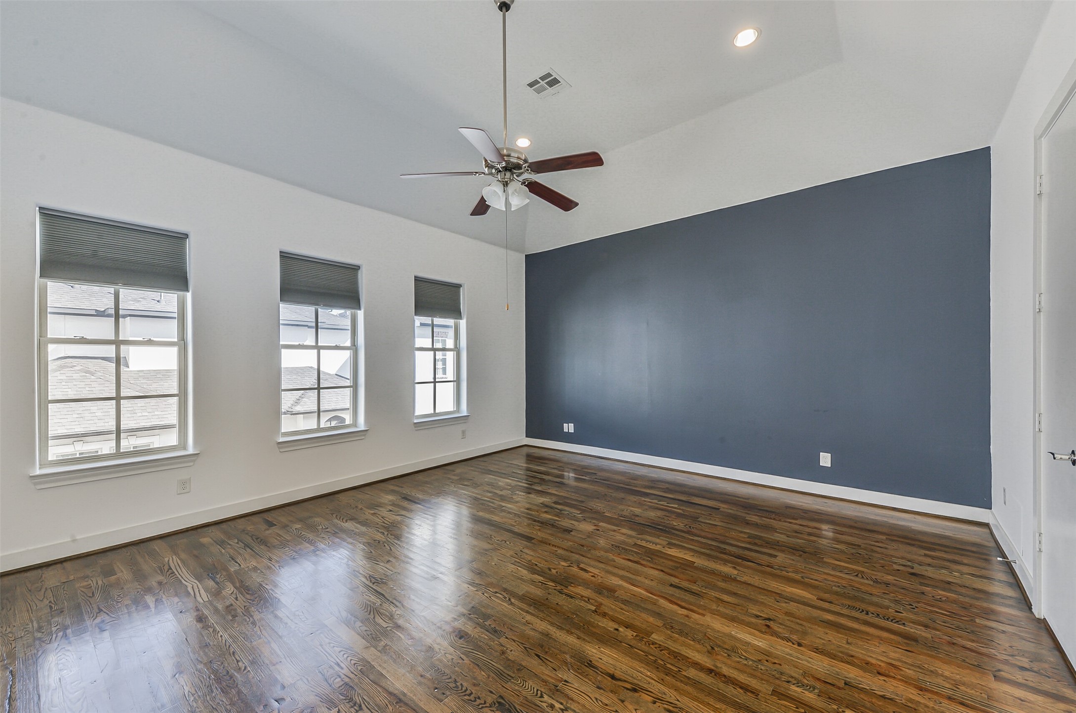 2715 Cohn Garden Lane Houston, TX 77007 - Photo 21 of 23 a view of an empty room with wooden floor and a window
