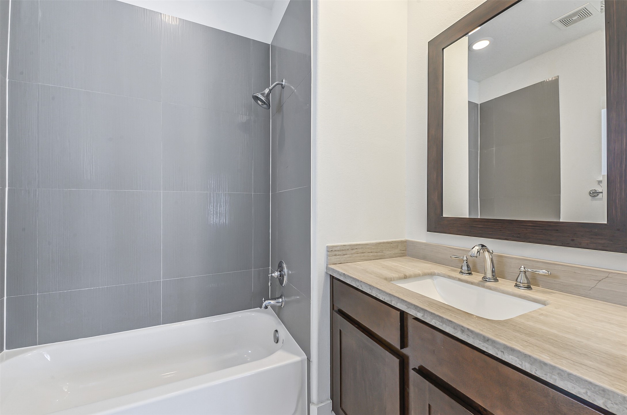 2715 Cohn Garden Lane Houston, TX 77007 - Photo 7 of 23 a bathroom with a granite countertop sink mirror and a bathtub