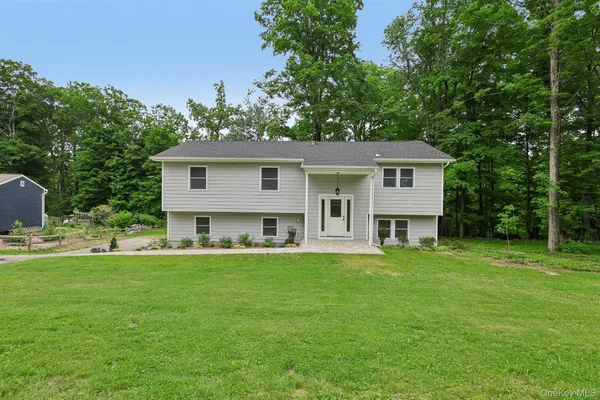 a front view of a house with a garden