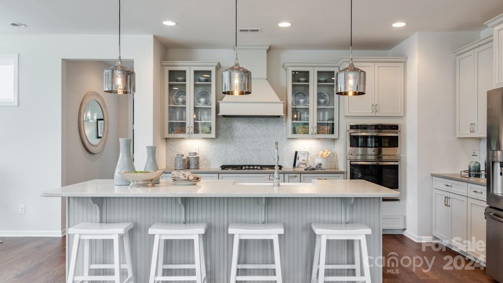 a kitchen with stainless steel appliances granite countertop a stove and a refrigerator