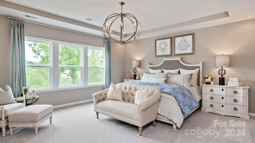 1237 Sugar Crk Road Indian Land, SC 29707 - Photo 16 of 25 a spacious bedroom with a bed a couch and a window