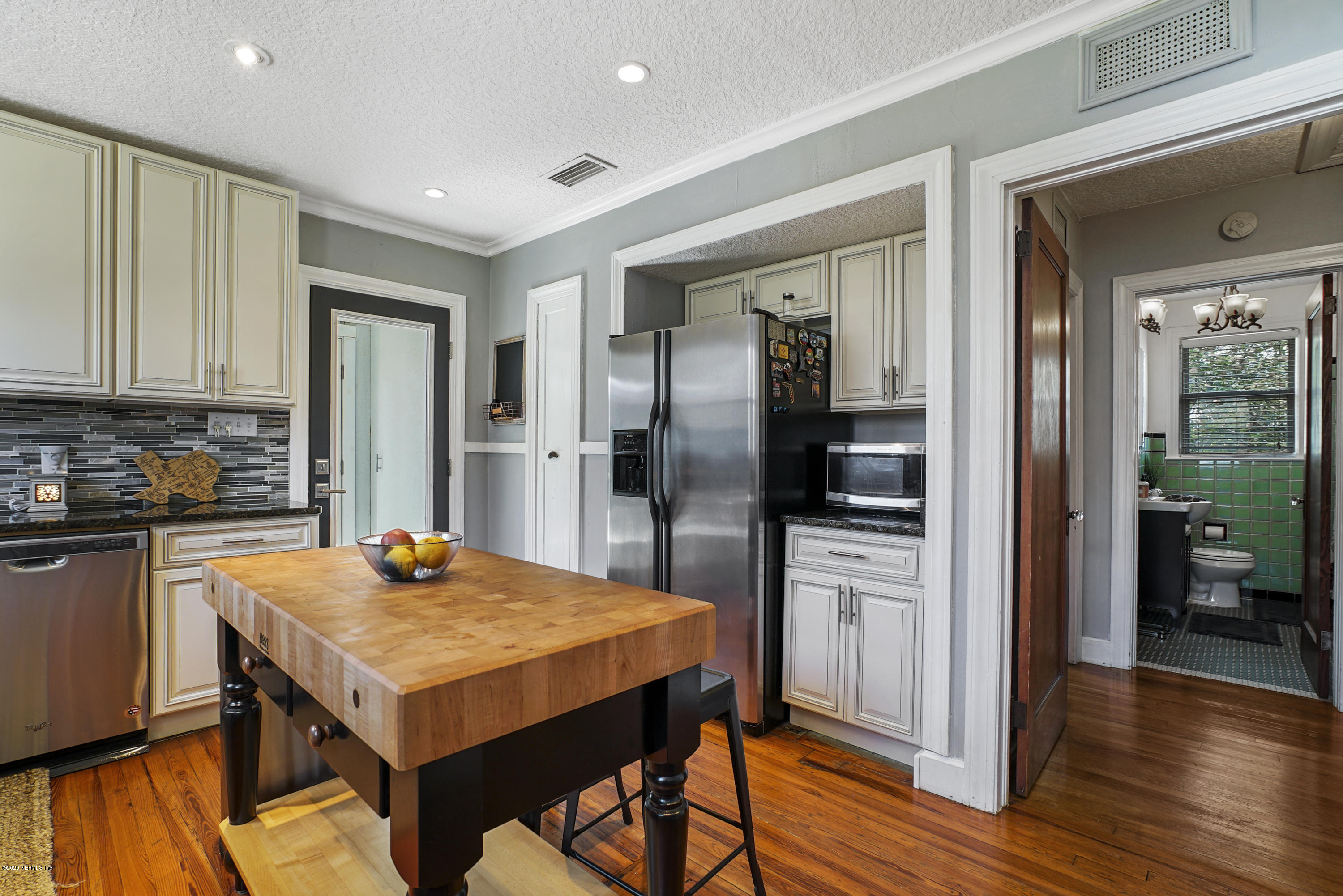 2212 Guilford Road Jacksonville, FL 32207 - Photo 12 of 20 a kitchen with stainless steel appliances a refrigerator and a stove top oven
