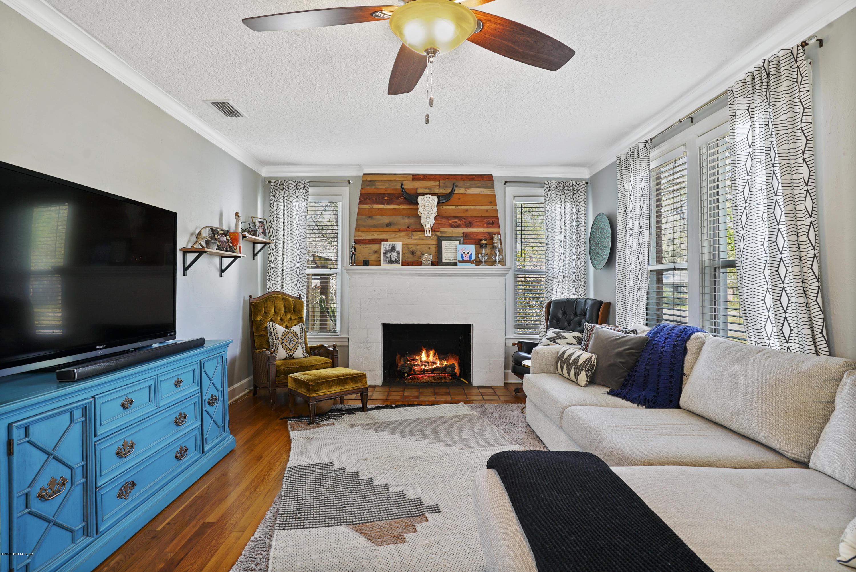2212 Guilford Road Jacksonville, FL 32207 - Photo 5 of 20 a living room with furniture a flat screen tv and a fireplace