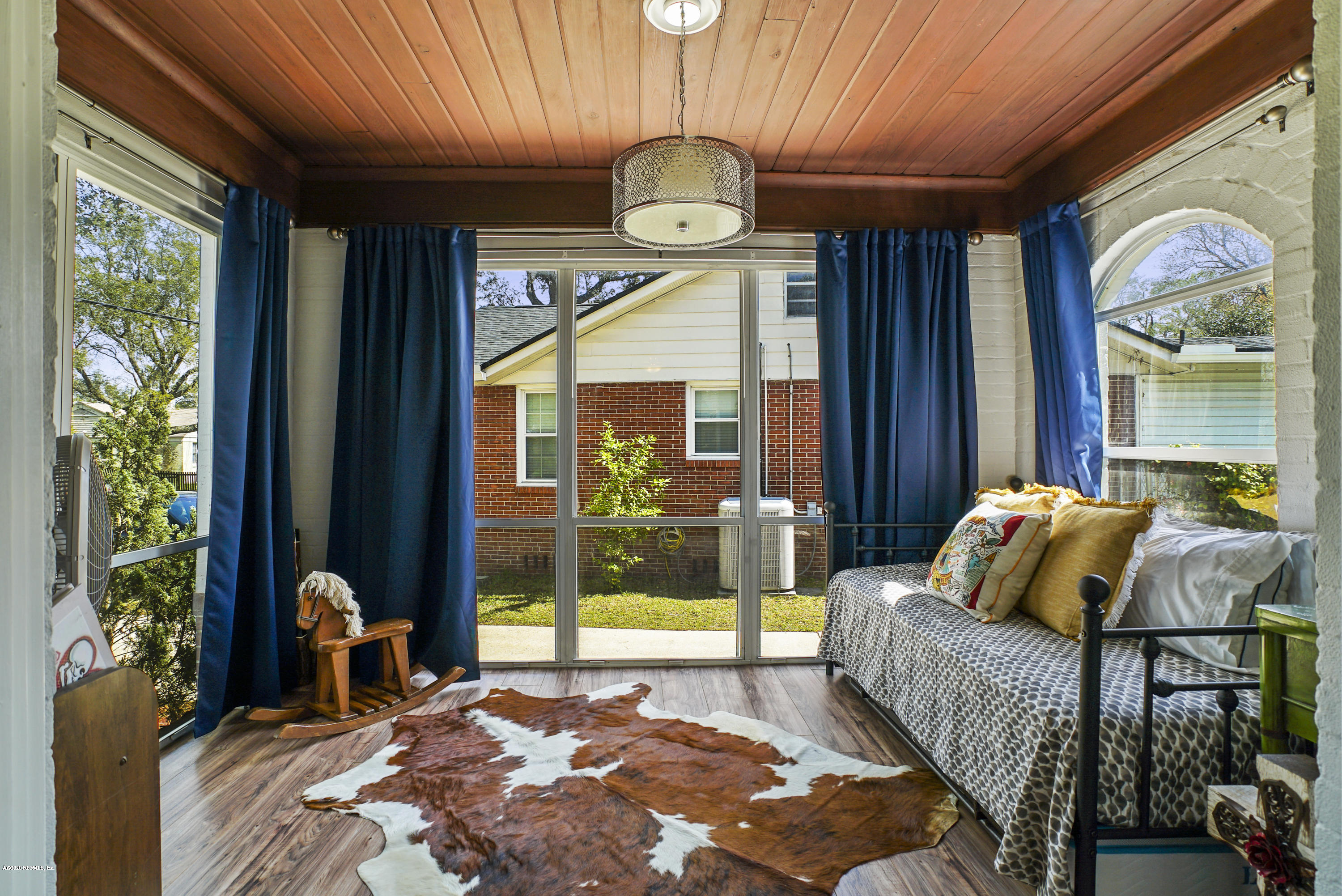 2212 Guilford Road Jacksonville, FL 32207 - Photo 7 of 20 a bedroom with a bed and a large window