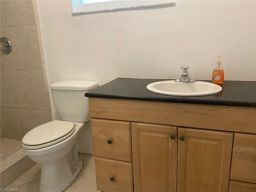 5241 Cypress Lane Naples, FL 34113 - Photo 11 of 15 a bathroom with a sink and toilet