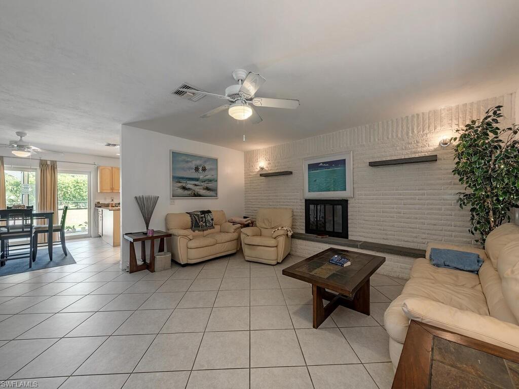 5241 Cypress Lane Naples, FL 34113 - Photo 13 of 15 a living room with furniture and wooden floor