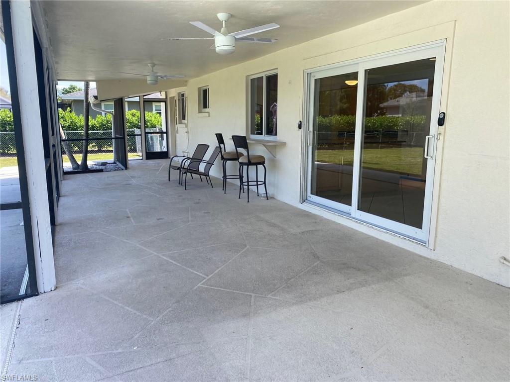 5241 Cypress Lane Naples, FL 34113 - Photo 7 of 15 a view of a livingroom with furniture and floor to ceiling window