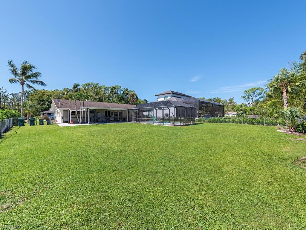 5241 Cypress Lane Naples, FL 34113 - Photo 8 of 15 a view of house with a big yard