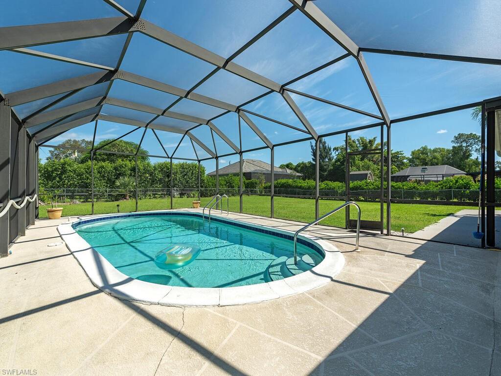 5241 Cypress Lane Naples, FL 34113 - Photo 9 of 15 a view of a backyard with swimming pool