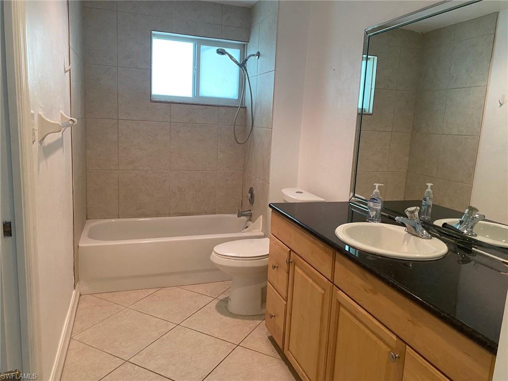 5241 Cypress Lane Naples, FL 34113 - Photo 10 of 15 a bathroom with a sink a toilet and shower