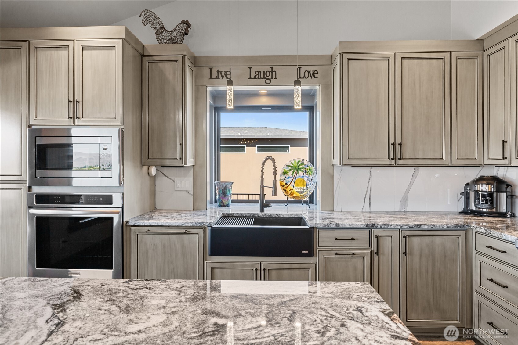 111 Wren Loop Southwest Mattawa, WA 99349 - Photo 11 of 40 a kitchen with kitchen island granite countertop a stove a sink and a refrigerator