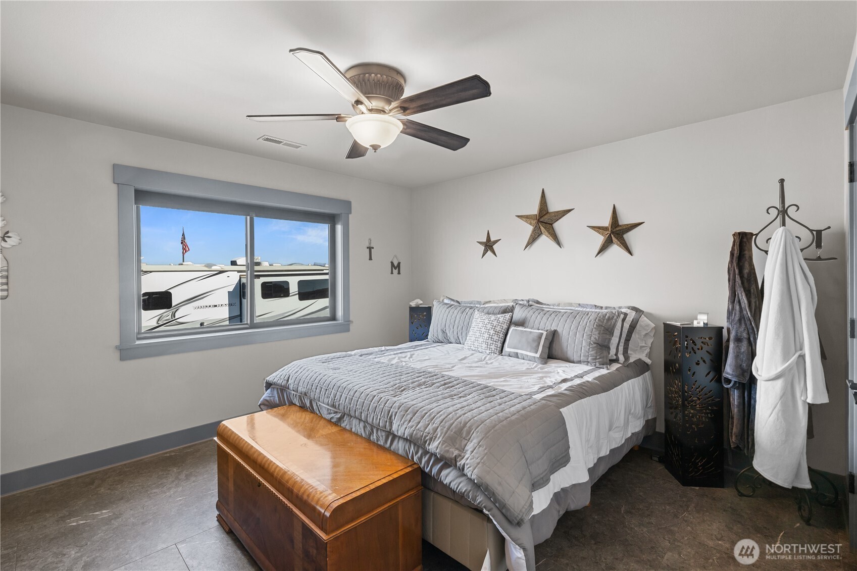 111 Wren Loop Southwest Mattawa, WA 99349 - Photo 19 of 40 a bedroom with a bed and a chandelier