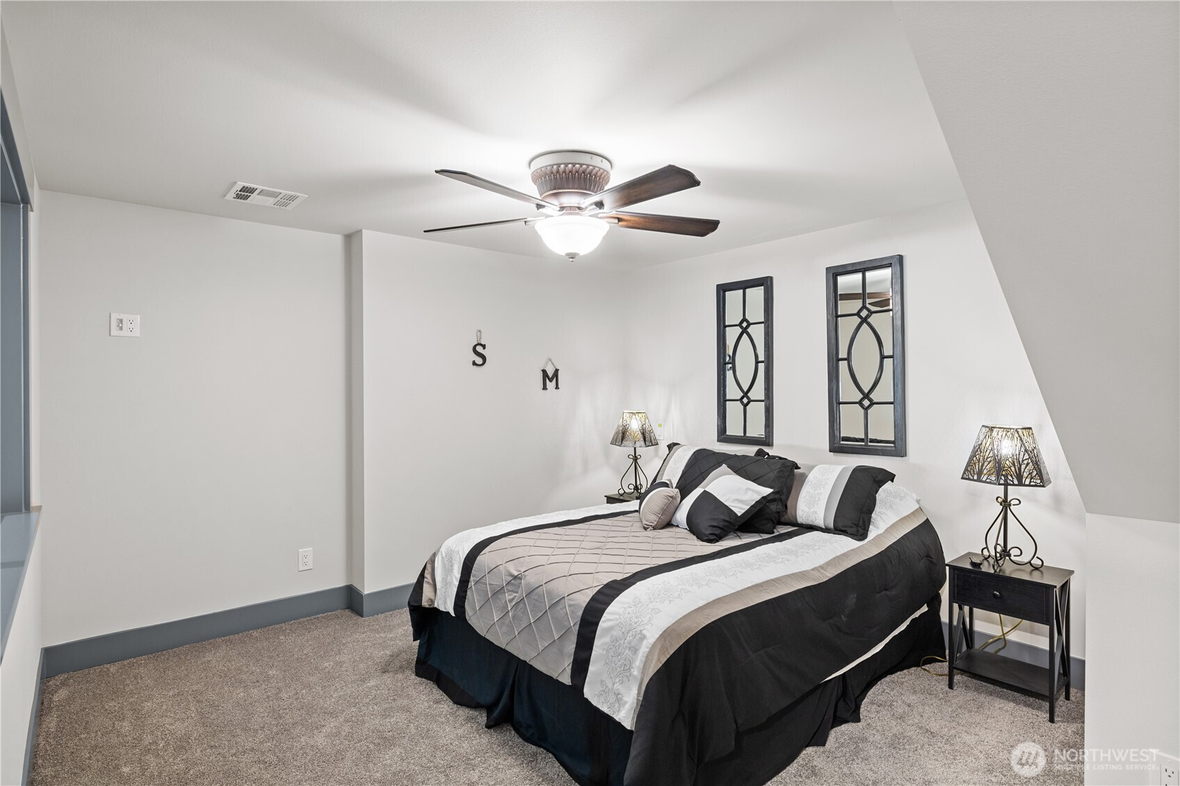 111 Wren Loop Southwest Mattawa, WA 99349 - Photo 23 of 40 a bedroom with a bed and a chandelier