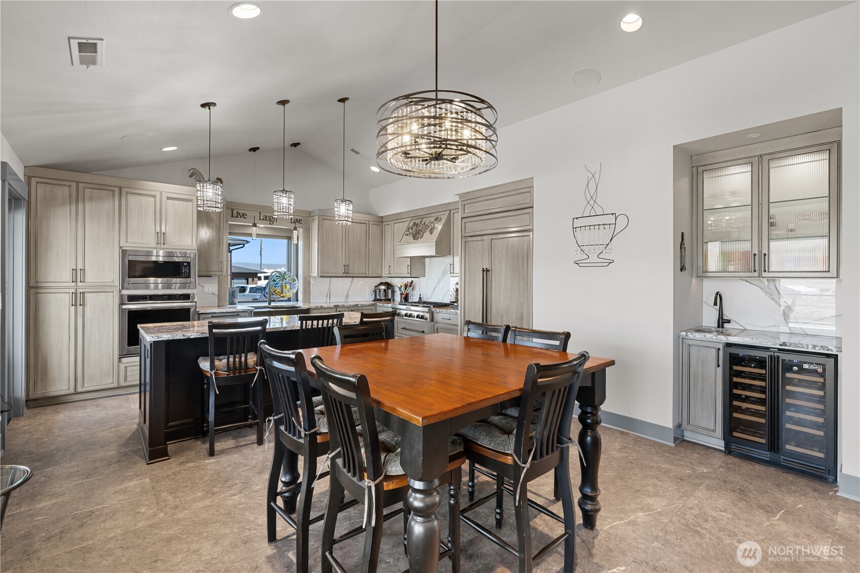 111 Wren Loop Southwest Mattawa, WA 99349 - Photo 9 of 40 a dining room with stainless steel appliances a table chairs and chandelier